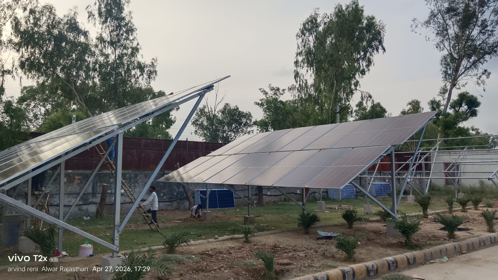 Garv Urja Solutions team installing a ground-mount solar array on site